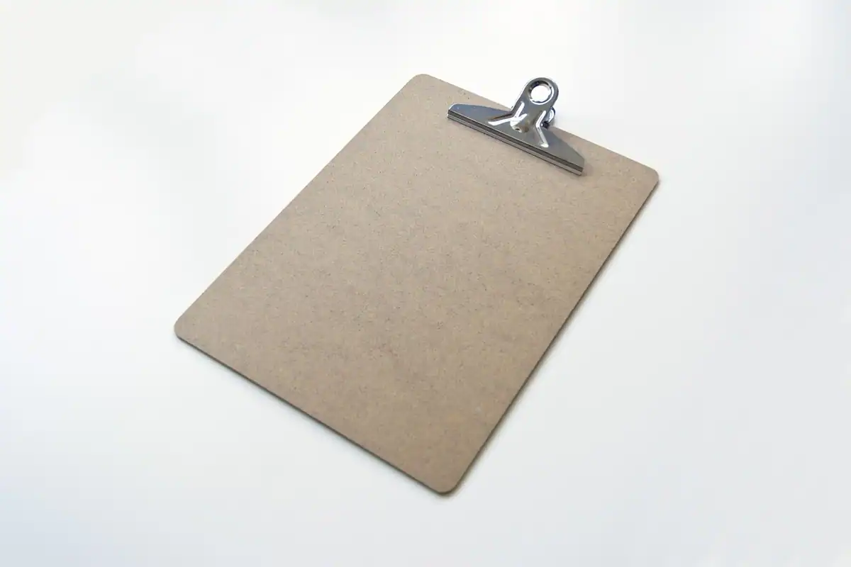 Clipboard cu listă de inventar goală, pe un birou, pentru bunurile predate la plecarea din firmă
